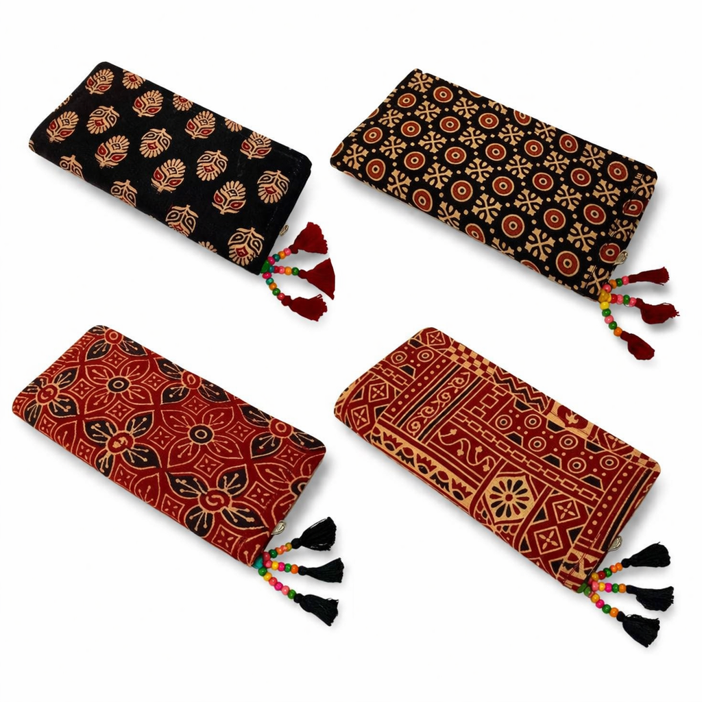 Four patterned pouches with tassels on a white background